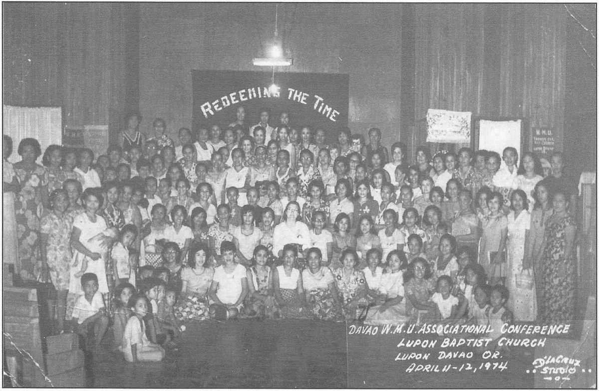 Women's Missionary Union delegates filling a church interior beneath a banner reading Redeeming the Time.